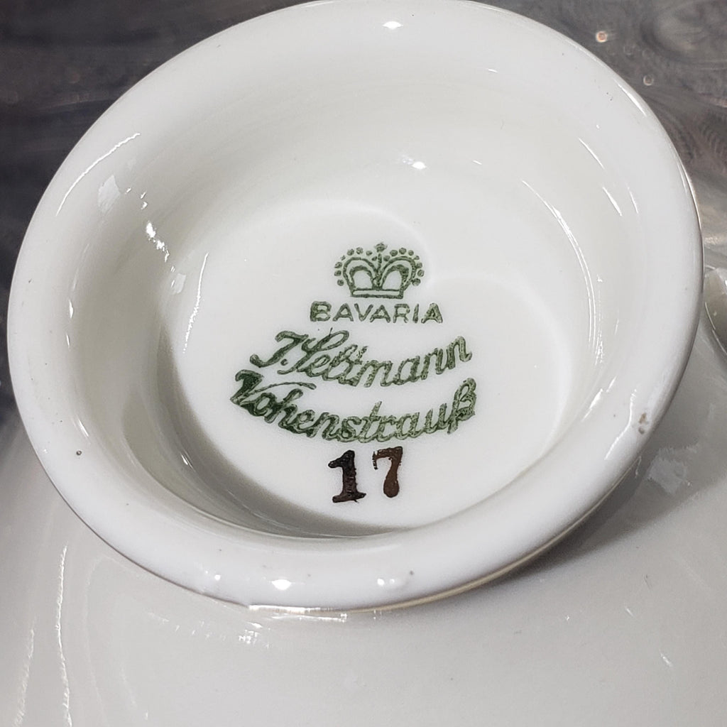 a close-up view of a white ceramic bowl with a green and gold logo on it.