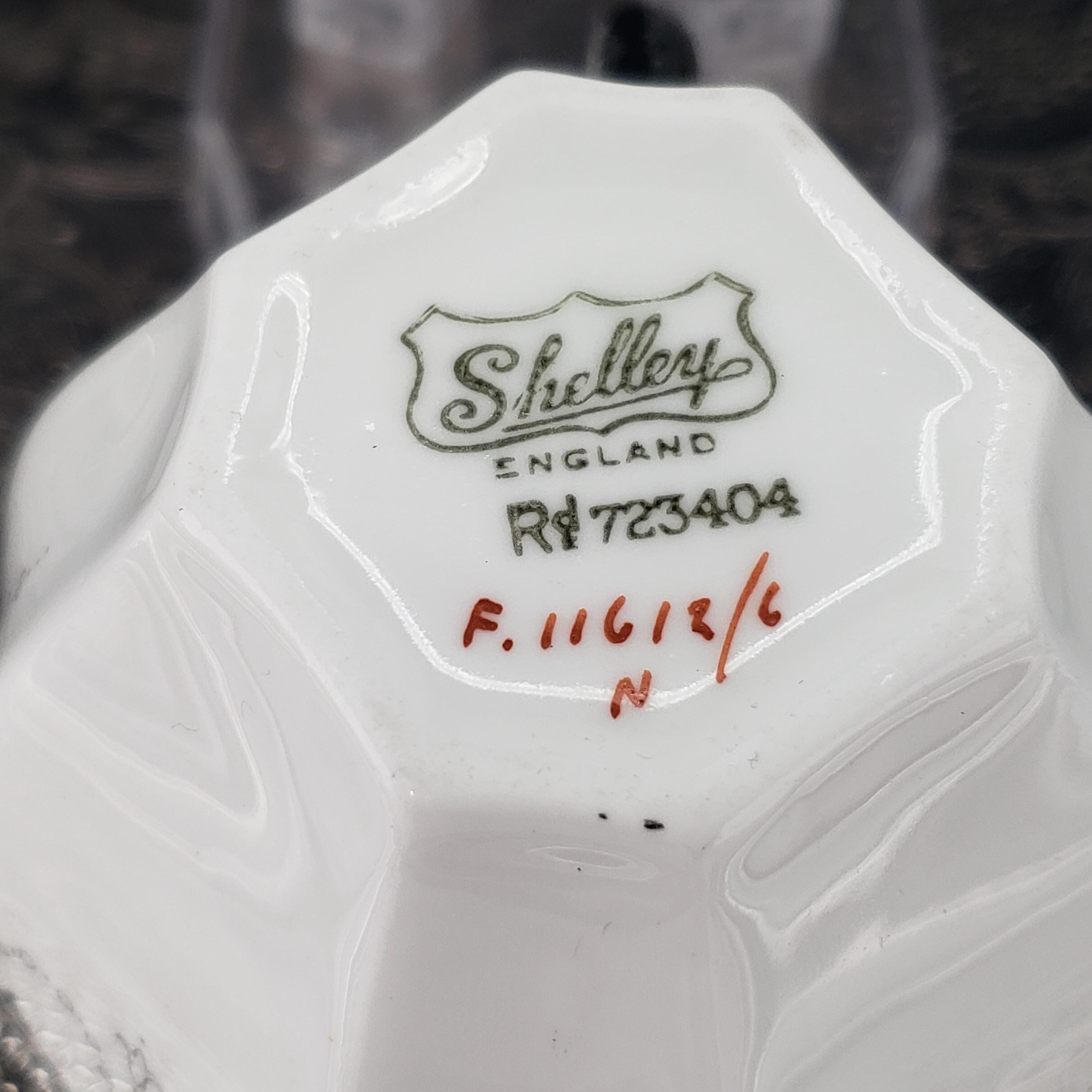 A close-up image of a white ceramic bowl or dish with the name 'Sheley' and some text printed on it.