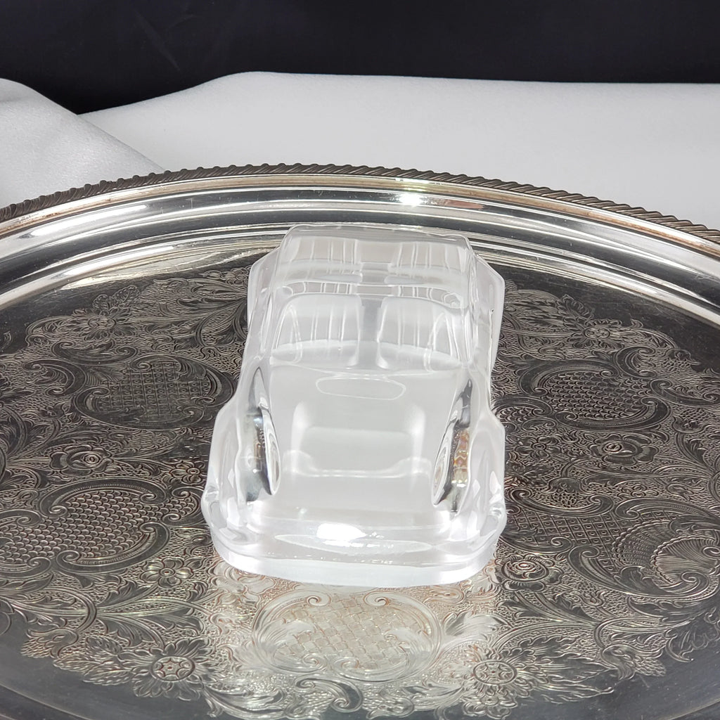 Clear vintage car-shaped glass trinket dish on an ornate silver tray