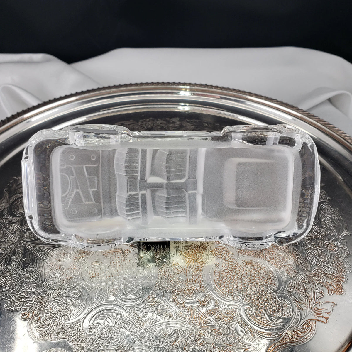 Vintage frosted glass rectangular dish on an ornate silver tray.