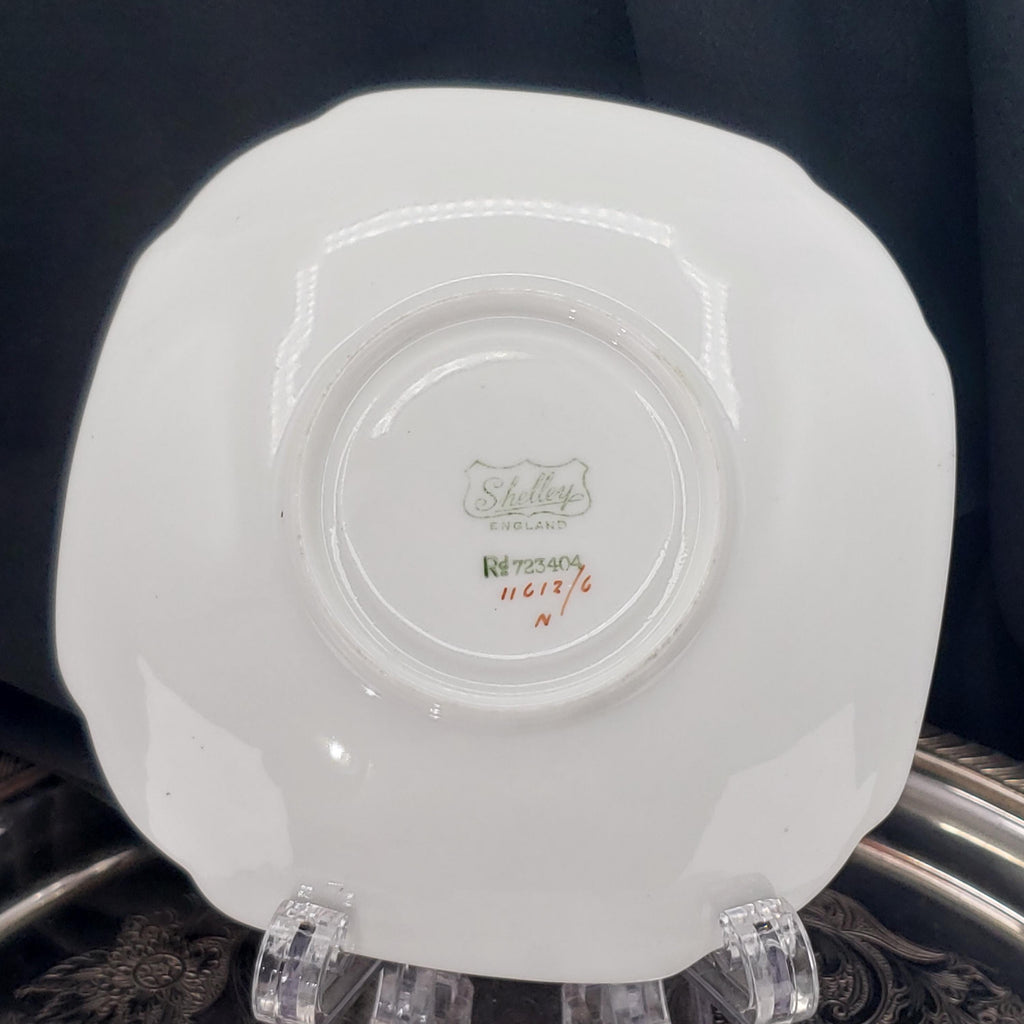 a white ceramic plate with a decorative design on the back.