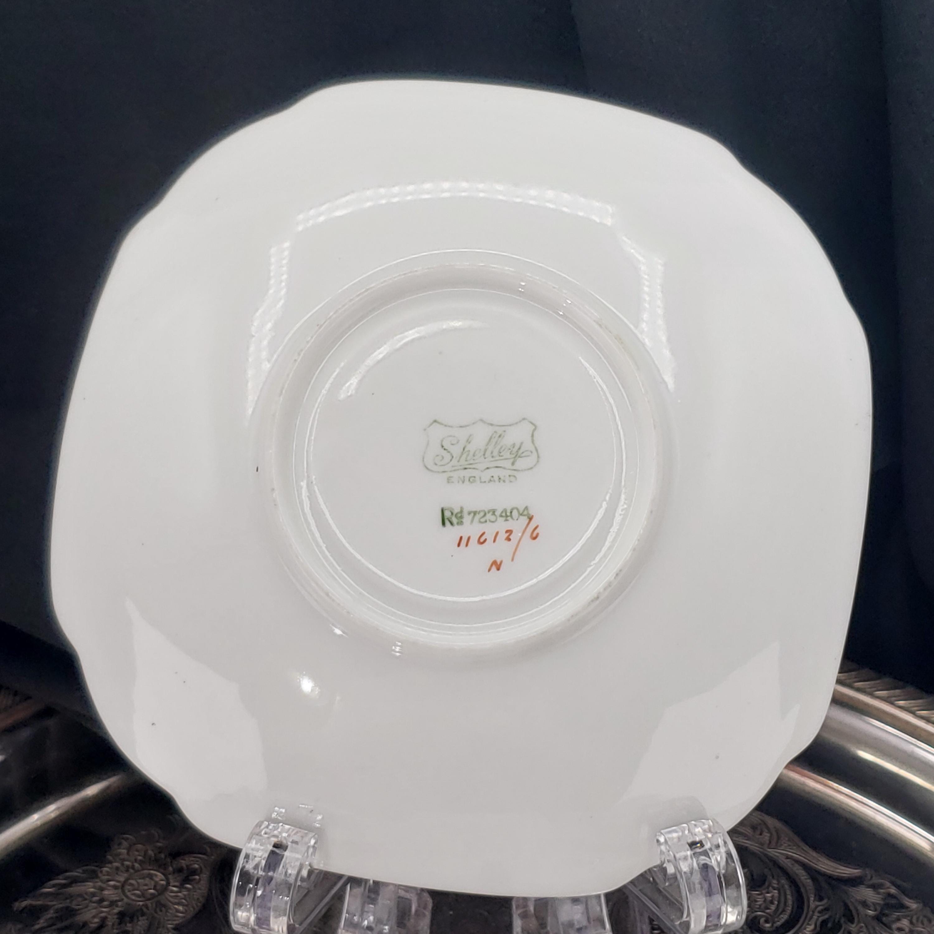 a white ceramic plate with a decorative design on the back.