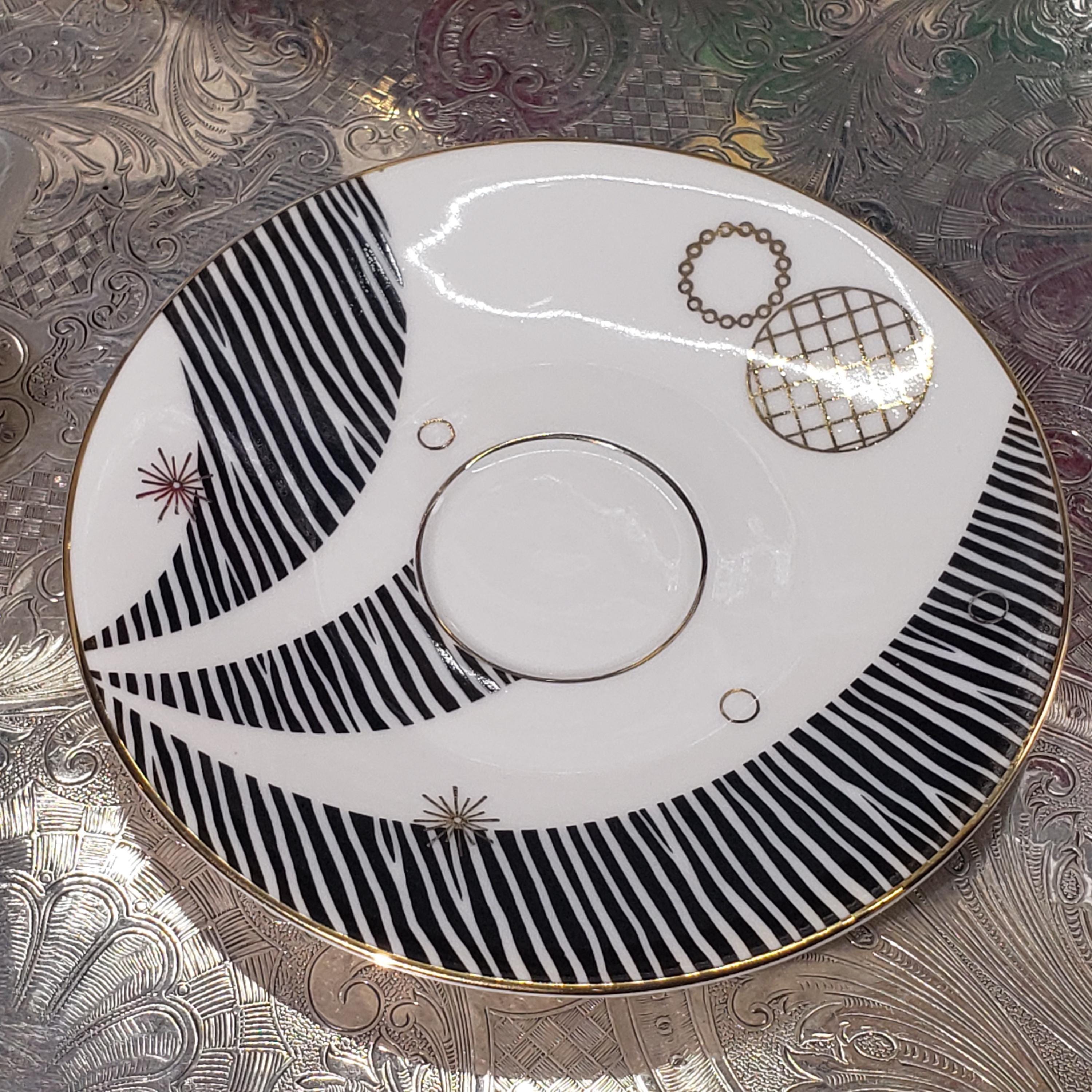 a decorative plate with a black and white striped pattern and a central circular design.