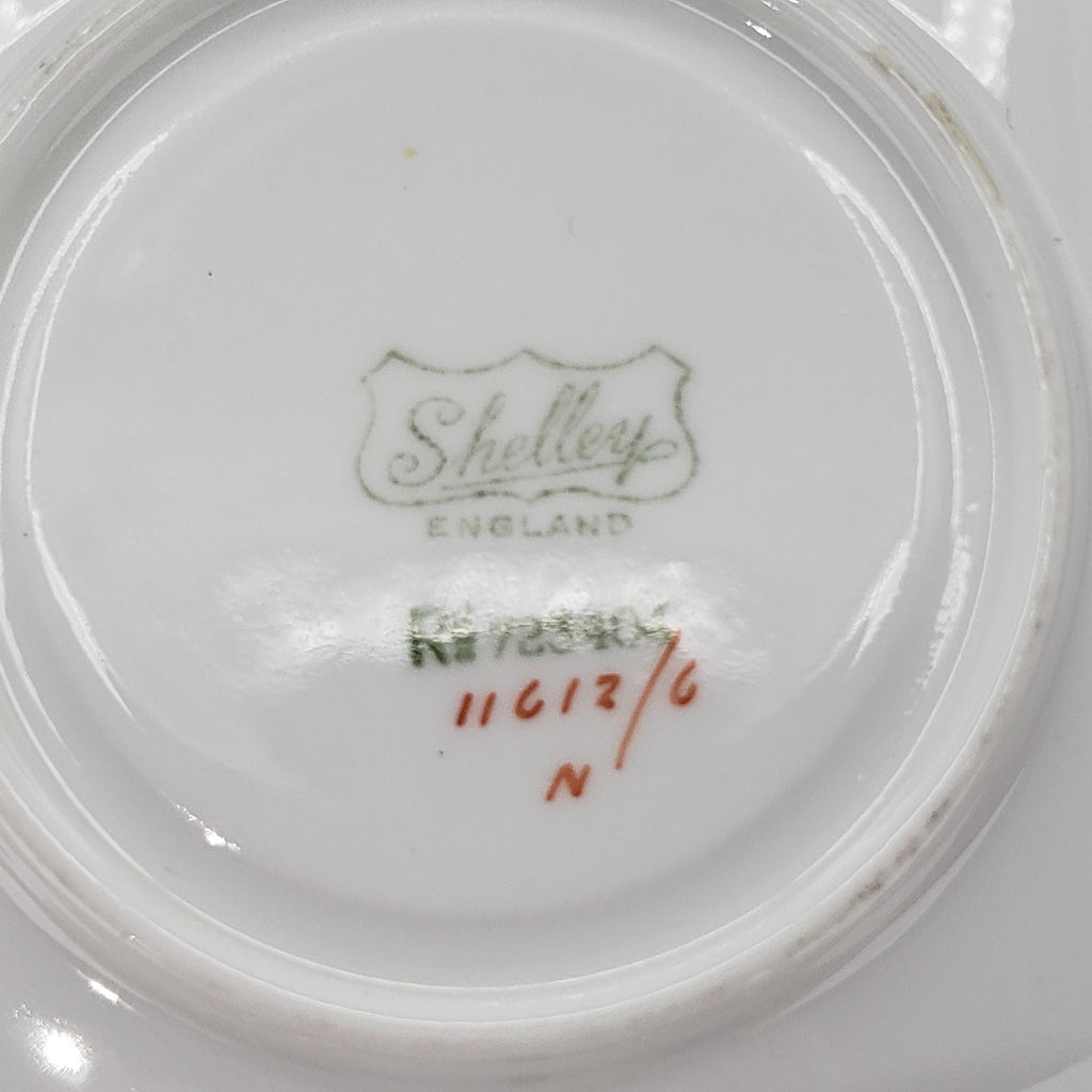 a close-up view of a white ceramic plate with a green and red design and text printed on it.