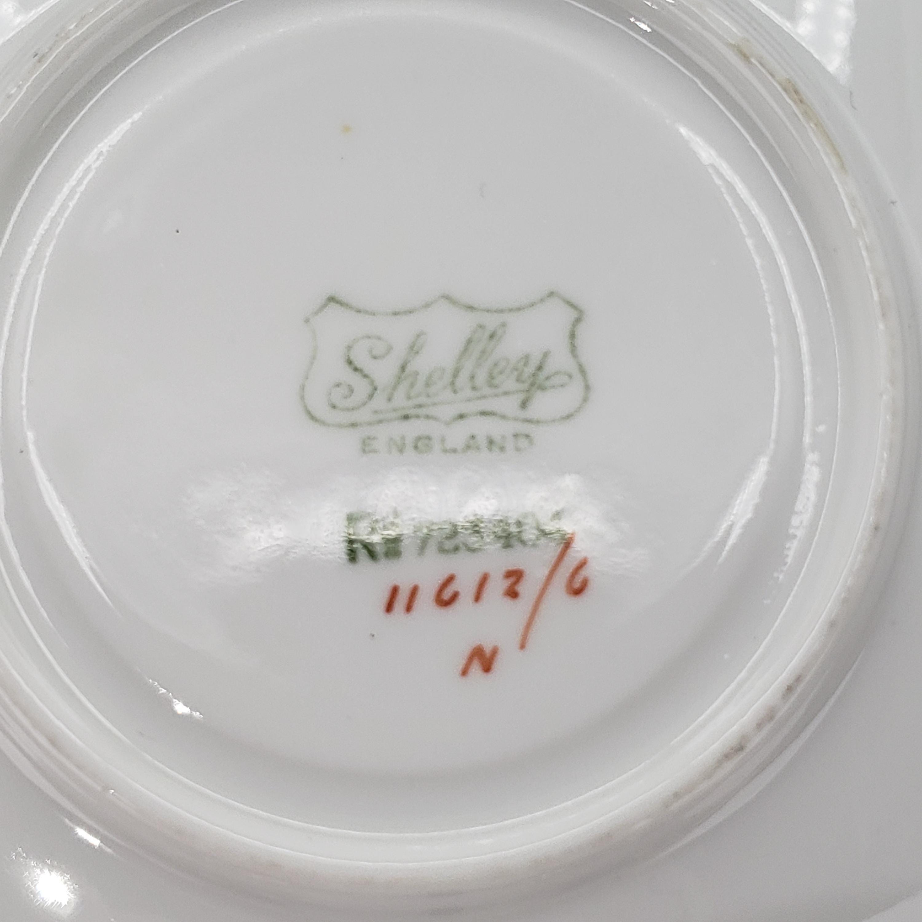 a close-up view of a white ceramic plate with a green and red design and text printed on it.