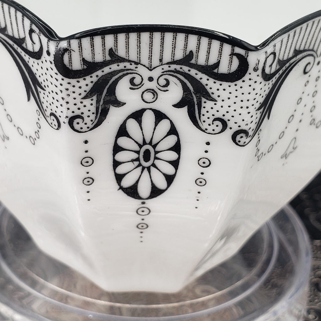 a close-up view of a decorative ceramic bowl with a floral pattern and a central oval design.
