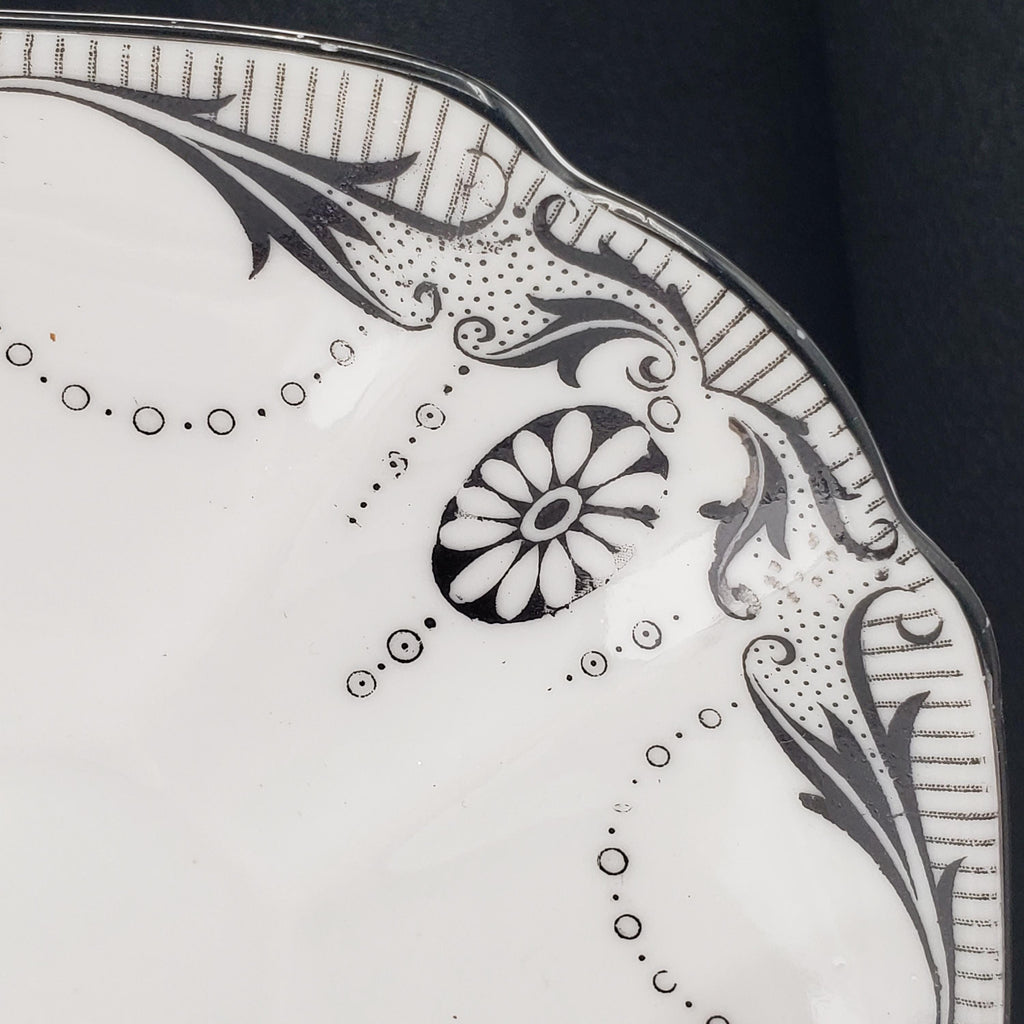 a close-up view of a decorative plate with a floral design and a central flower motif.