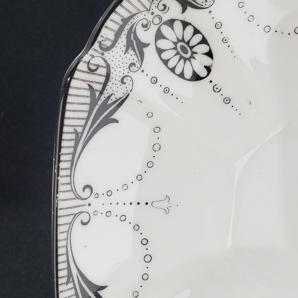 a close-up view of a decorative plate with a floral pattern and a central flower design.