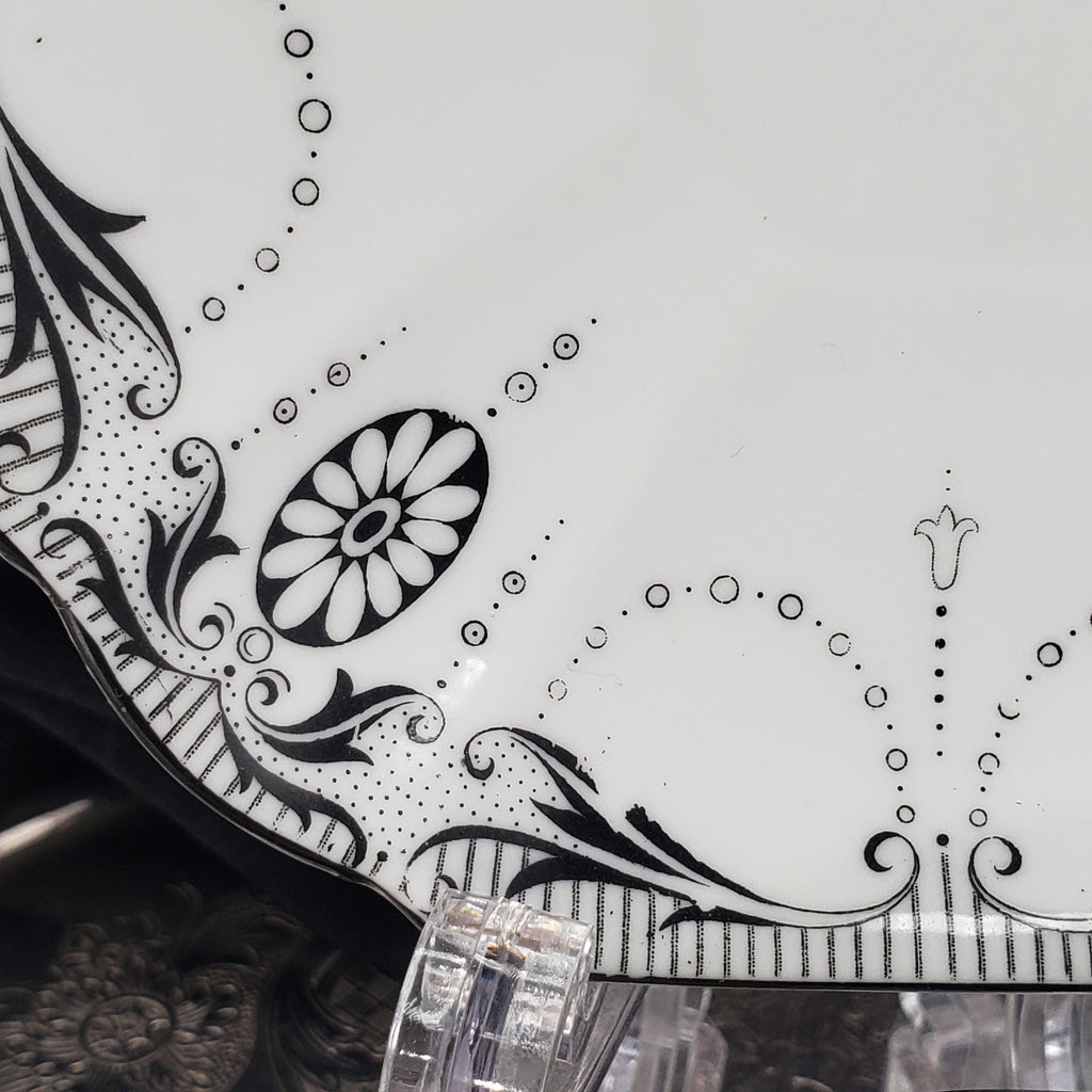 a decorative plate with a floral design and a central flower motif.