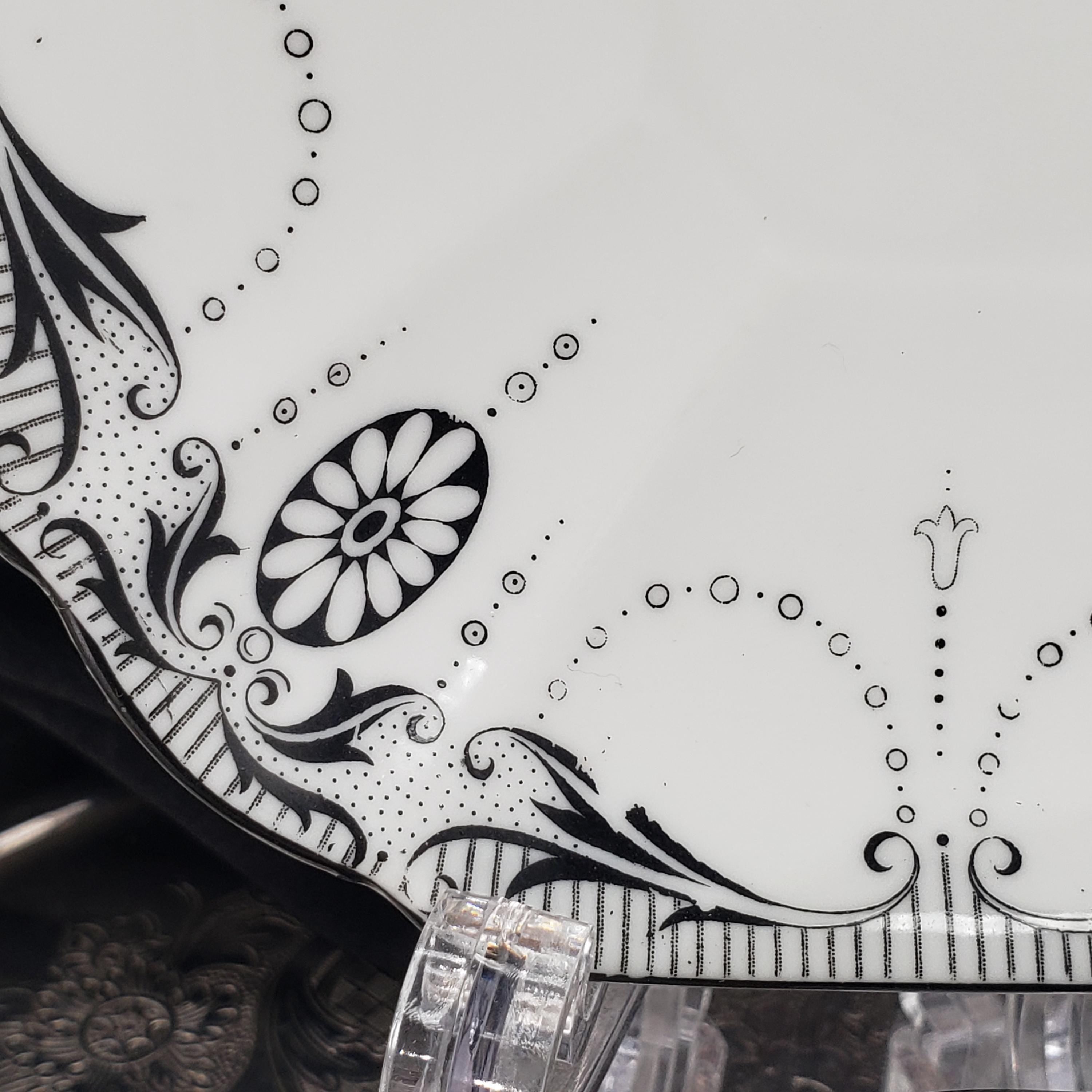 a decorative plate with a floral design and a central flower motif.