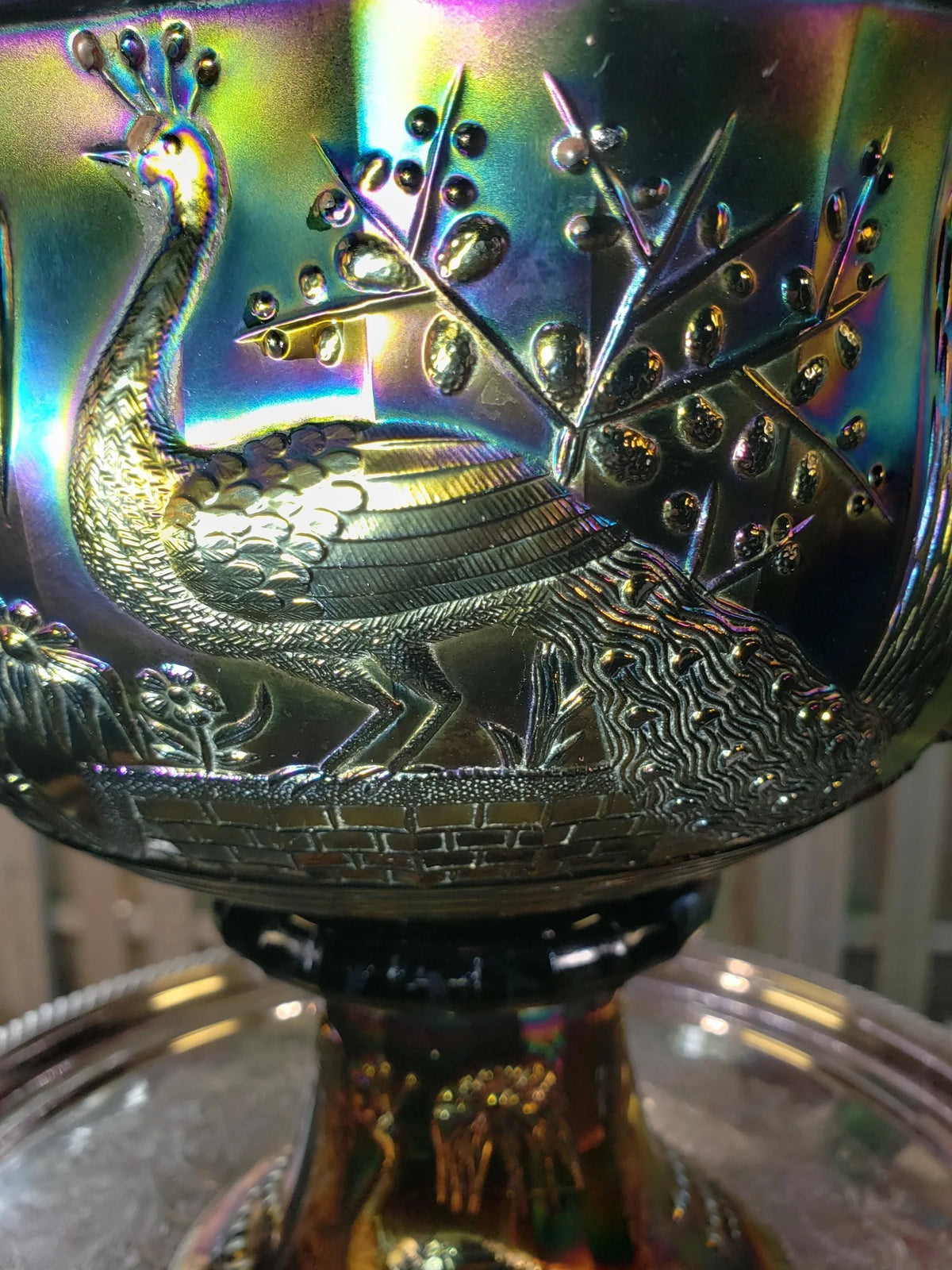 a close-up view of a decorative bowl with a peacock design.